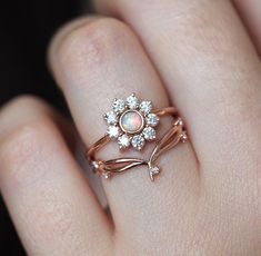 A colorful nature inspired opal and diamond flower ring with a round 4mm genuine Australian opal and a halo of white diamonds. Perfect as a unique floral engagement or wedding ring in 14k or 18k solid gold or platinum, here pictured in rose gold. The design can be made with gemstones of your choosing. If you would prefer other gemstones instead of diamonds/opals or a custom design, please contact us before purchase. Item details Main gemstone: genuine round Australian opal Measurements: approx. Ruby Stone Ring, Opal Diamond Ring, The Bling Ring, Flowers Jewelry, Rose Engagement Ring, Halo Diamond Ring, Diamond Flower, Australian Opal, Sapphire Engagement