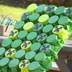 a bunch of green cupcakes sitting on top of a wooden table