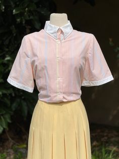 Vintage Multi Pastel Colored Striped Button-Up Collared Short Sleeve Blouse  -Velcro Collar -Solid white trim -Colors: White, pink, blue, yellow  No marked size. Please go by measurements. Measurements (laid flat, not doubled): Shoulder to shoulder: 16" Underarm to underarm: 23" Hem across: 24" Full length: 26" Condition: Excellent! Spring White Blouse With Striped Collar, White Blouse With Striped Collar For Spring, Fitted Top With Contrast Collar For Spring, White Striped Collar Button-up Blouse, White Button-up Blouse With Striped Collar, Fitted Button-up Top With Contrast Collar, Preppy Blouse With Button Closure, Fitted Tops With Contrast Collar And Button-up, White Preppy Blouse For Spring