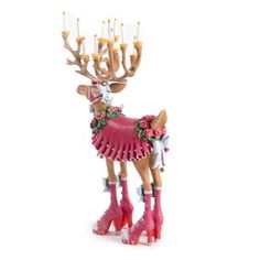 a reindeer with pink boots and flowers on it's head is standing in front of a white background