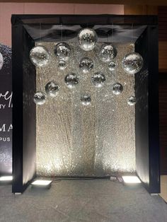 an open door decorated with silver balls and lights