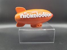 an orange toy airplane with the words nickeleoden on it's side