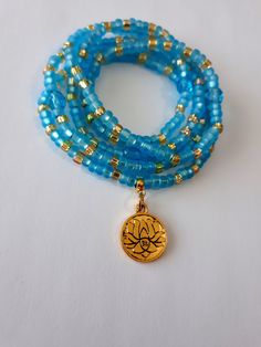 Waist beads made with 4mm matte sky blue and gold crystal seed beads, 6mm Czech glass beads, and 16mm lotus charm with ohm symbol. Beads are on sturdy elastic cord. Gold Waist Beads, Waist Beads African, Ohm Symbol, Belly Beads, Beads Waist, Beaded Braclets, Waist Jewelry, Chakra Beads, Waist Beads