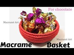 a basket filled with lots of chocolates on top of a white table next to the words macrame art