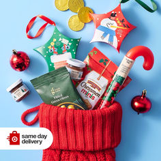 an assortment of holiday items in a red knitted bag on a blue background with the caption same day delivery