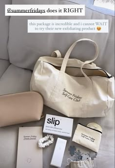 a white bag sitting on top of a couch next to some tags and other items