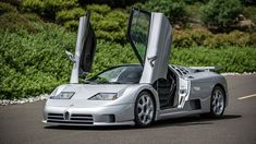 a silver sports car with its doors open