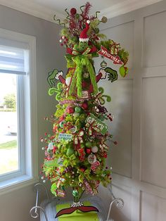 a decorated christmas tree in the corner of a room