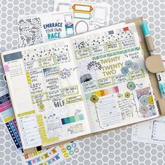 an open planner with lots of stickers on it