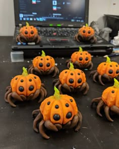 there are many pumpkins that have been made to look like spider's on the table