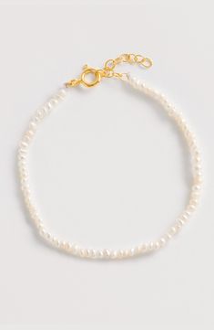 Elevate your designer jewelry collection with this beautiful Seed Pearl bracelet. Handcrafted from luxurious 18ct Gold vermeil-plated sterling silver and seed pearls, this lightweight statement pearl bracelet is timeless, perfect for a bride-to-be or gifting for her. A fabulous day-to-night bracelet to add a touch of glamour and style.Adjustable length bracelet made from Seed Pearls & 18ct yellow gold plated sterling silver. Maximum length: 20.5cm Minimum length: 18cm Delicate Pearl Beaded Bracelets For Formal Events, Delicate Pearl Beaded Bracelets For Formal Occasions, Delicate Pearl Beaded Bracelet For Formal Occasions, Elegant Single Strand Pearl Bracelet For Wedding, Elegant White Gold Bracelet With Pearl Chain, Timeless White Pearl Bracelet As A Gift, Timeless White Pearl Bracelet As Gift, Timeless Pearl Bracelets For Wedding, Elegant White Gold Bracelet With Pearl Drop