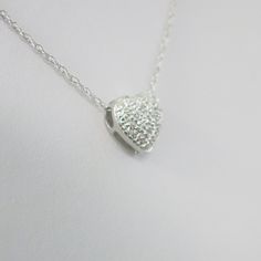 Single cut diamonds are pave set into this 14k white gold heart pendant. A Singapore white gold chain is the perfect addition to complete this necklace. Metal: 14K White Gold Necklace Length: 16 Inches Pendant Length x Width: 3/8 x 3/8 Inches Diamonds: .17 CTW, SI1 E-F For a greater selection of jewelry please visit our website at www.BlackMarketLLC.com If you have any questions about this product or if we can help you with any of our other products please contact us through Etsy or our website White Gold Heart-shaped Necklace With Pave Setting, White Gold Heart Cut Necklace With Pave Setting, Silver Heart-shaped Diamond Necklace With Pave Setting, White Gold Heart Cut Diamond Necklace With Pave Setting, Valentine's Day White Diamond Necklace With Single Cut Diamonds, White Heart Pendant Necklace With Pave Setting, White Gold Sterling Silver Heart Necklace With Diamond Accents, Heart-shaped White Gold Necklace With Pave Setting, White Gold Heart Necklace With Pave Setting