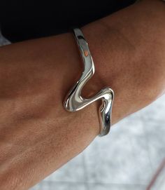 Sterling Silver Wave Bracelet, Open Cuff Bracelet, Bracelet for Women, Chunky Silver Bracelet, Modern Bracelet, Geometric Bracelet Although made from thick silver there is a certain amount of give in the bangle allowing you to adjust it by carefully squeezing the ends together or pulling open slightly. To determine your size, please measure the circumference of your wrist with a tape measure or piece of paper. The cuff has a slight flexibility to allow you to fit it to your own wrist once it is Timeless Silver Bracelet, Luxury Modern Cuff Sterling Silver Bracelet, Chunky Silver Bangle, Chunky Silver Bracelets, Silver 925 Jewelry, Unique Silver Bracelets, Designer Silver Jewelry, Silver Jewelry Chunky, Layering Bracelets Silver