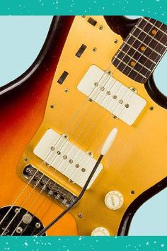 an orange and black electric guitar on a blue background