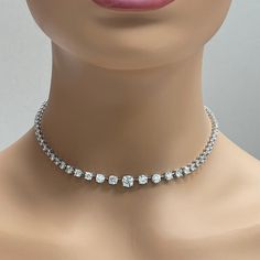 A classic and elegant everyday or occasional wear with graduating diamond sizes, this Space Necklace is a fresh take on a versatile piece of jewelry. All our necklaces have two locks for added security. Center Diamond Weight: 1.00 ct Center Diamond Color: I Center Diamond Clarity: SI (Slightly Included) Total Diamond Weight: 11.53 ct No. of Diamonds: 77 Diamond Color: H - J Diamond Clarity: SI - I (Slightly Included - Included) Metal: Platinum Metal Wt: 32.15 gms Setting: Prong Set Length: 15.75 Classic Crystal Tennis Necklace With Brilliant Cut, Classic Diamond Cut Crystal Tennis Necklace, Classic Crystal Diamond Necklace With Brilliant Cut, Classic Brilliant Cut Crystal Diamond Necklace, Classic Round Cut Crystal Diamond Necklace, Vvs Clarity Diamond Necklace In Classic Style, Classic Round Cut Crystal Necklace, Elegant Crystal Tennis Necklace With Prong Setting, Formal Diamond Choker Necklace In Fine Jewelry Style