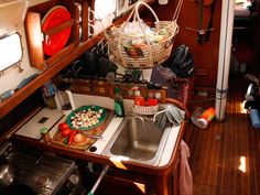 a kitchen area with sink, stove and oven in a small boat or houseboat