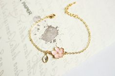 Super dainty Personalized Cherry blossom bracelet. ▶▶ You can make this necklace personal choosing the quantity of letter leaf from option. Please leave a note for the desired letters in 'add your personalization' ▶ Material - Gold plated over brass, Pearl ▶ Chain Length - 5 ~ 9 inches (Please choose it from option) ▶ charm measure - Flower H. 14mm x W. 13mm, Initial leaf ▶ The matching necklace available https://www.etsy.com/listing/196300602/cherry-blossom-necklace-sakura-necklace The matching Pink Flower Charm Jewelry For Bridesmaid Gift, Cute Rose Gold Flower Jewelry, Dainty Flower Shaped Personalized Bracelets, Cute Flower-shaped Bracelet, Cute Flower-shaped Gift Bracelets, Cute Flower Bracelets For Gifts, Cute Flower Bracelet For Gift, Cute Flower Shaped Bracelet For Gift, Pink Flower-shaped Bracelet Gift