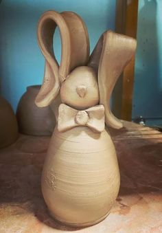 a clay sculpture with a bow tie on it