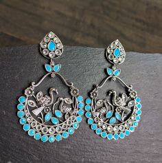 Fun & Flirty chand balis with nature inspired details that compliments your kalamkari, fusion, casual outfits Color: Turquoise Length: 3 Inches Width: 2.75 Inches Bohemian Silver Chandbalis With Matching Earrings, Bohemian Style Dangle Chandbalis For Pierced Ears, Bohemian Chandbalis With Dangle Shape, Bohemian Dangle Chandbalis, Traditional Turquoise Earrings For Party, Festive Bohemian Bridal Dangle Earrings, Bohemian Peacock Design Earrings For Wedding, Bohemian Earrings With Oxidized Finish For Festivals, Bohemian Metal Earrings With Peacock Design