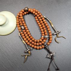 ❤This bodhi beads mala is made by Tibetan craftsmen and come from Hepo Town, Baiyu County, the birthplace of the famous Tibetan handicrafts,about 30 years old, hold and blessed by a lama in Baiyu Monastery.It is composed of 108 bodhi seed beads, and is equipped with 3 cold iron dzi beads, cold iron bead counters are installed on both sides, 1 mani jewel bead clip,and finally consists a skull guru bead and vajra on the end, very elegant.❤Details1. Handmade 108 bodhi beads approximately 8-9mm,mala Bodhi Leaf, Wrist Mala, Beads Mala, Tibetan Jewelry, Iron Beads, 30 Years Old, A Skull, Silver Bead, Mala Beads