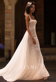 a woman in a white dress is walking down the street