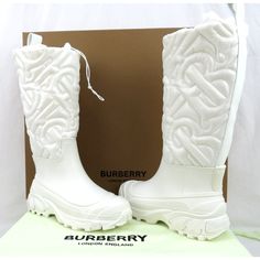 Rotherfield White Rubber Tb Monogram Logo Quilted Rain Boots By Burberry 100% Authentic, Guaranteed !!! Color: Optic White (Print On The Box) Article: 8058889 Rubber Waterproof Bottom Part Tb Monogram Quilted Nylon Upper Pull-On Silhouette Drawstring Adjustable Top Back Leather Trim And Pull Loop Embossed Logo At Heel Round Reinforced Toe Insulated Wool Blend Insole Wool Blend Fleece And Leather Lining Rubber Slip-Resistant Sole Size: Eur 37 / Uk 4 (Print On The Shoes And Box) - Us 7 Msrp: $1190 White Rain Boots, Burberry Store, Monogram Quilt, Luxury Stuff, Chanel White, Snow Rain, Fashionable Shoes, Burberry Shoes, Monogram Logo