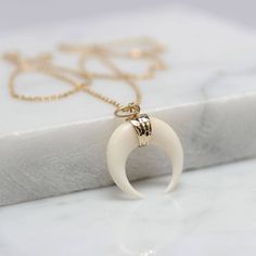 Double Horn Crescent Moon Necklace Pendant This eye-catching white double horn pendant can be your ultimate everyday accessory and may just be in the running as your perfect piece! This pendant is made of elegantly handcrafted and hammered 925 Sterling Silver / 24ct Light Gold Fill with white horn. It can be worn alone or layered up with other necklaces. We have developed and perfected a 'hand - hammered' finish, which creates a light reflecting textured surface that twinkles. Our jewelry is han White Crescent Handmade Necklace, Handmade White Crescent Necklace, Minimalist White Crescent Jewelry, Minimalist White Crescent Necklace, Double Horn Necklace, Handmade Rose, Horn Necklace, Horn Pendant, Hammered Sterling Silver