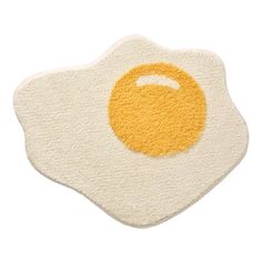 an egg shaped rug on top of a white surface