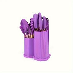 purple kitchen utensils in a holder on a white background