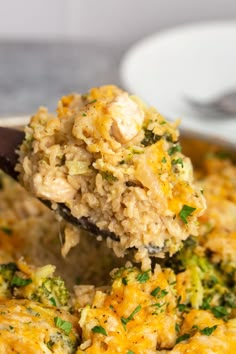 broccoli and rice casserole being lifted with a wooden spoon