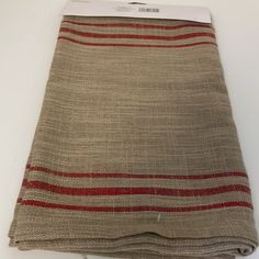 a piece of cloth with red and white stripes on the bottom, sitting on top of a table