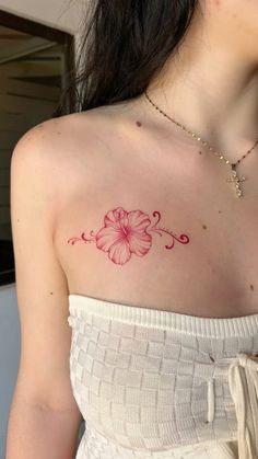 a woman with a flower tattoo on her chest