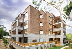 an apartment building with balconies on the second floor