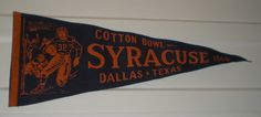 an orange and black pennant hanging from the side of a building that says, cotton bowl - syracuse, dallas & texas