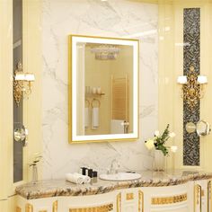 a bathroom with marble counter tops and gold accents