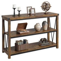 a wooden shelf with books, vases and pictures on it next to candlesticks