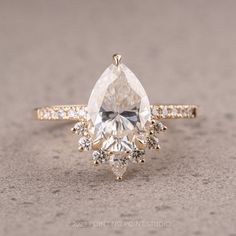 an engagement ring with a pear shaped diamond