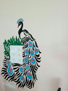 there is a peacock painted on the wall next to a light switch box and pen