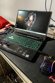 an open laptop computer sitting on top of a desk next to a mouse and keyboard