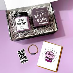 the contents of a bath bomb gift box are displayed on a purple background with a note card and bracelet