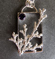 "Here is a handmade pendant made of sterling silver with an amethyst. I created a rectangular frame as the base of this pendant. I then cast a sprig of cypress from a tree in my yard. It is cast using a method like lost wax casting but in this cast it is lost plant casting. The plant material is burned away in my kiln leaving a cavity that is then filled with molten silver leaving an exact replica in solid sterling silver. A 6mm faceted amethyst is in the corner. The chain is sterling silver rou Lost Wax Casting Jewelry Pendants, Lost Wax Pendant, Purple Sterling Silver Rectangular Jewelry, Purple Rectangular Sterling Silver Jewelry, Wax Casting Jewelry, Lost Wax Casting Jewelry, Fused Jewelry, Wax Carving Jewelry, Texture Ideas