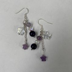 Amethyst and Crystal Star Dangle Earrings | Purple Star Earrings | Cute Accessory A cute pair of amethyst star dangle earrings for any occasion! Includes two earrings in a pair made just for you! Gift it to a friend or keep it for yourself. Perfect for the hard to gift for friend. :D Length : 2.5 inches  Make time : Will be made and shipped out within 1 - 3 days  Contact us with any issues and we will guarantee to make it right.  Handmade item by Audrey and Ruby from BugsandSlugsShop. Colors may vary slightly due to photo lighting. Check out our other products at BugsandSlugsShop and follow our instagram @bugsandslugsshop to keep updated on new listings and sales ! Purple Star Earrings, Star Bead Earrings, Purple Earrings Aesthetic, Purple Accessories Aesthetic, Whimsigoth Earrings, Purple Dangle Earrings, Star Dangle Earrings, Purple Accessories, Purple Star