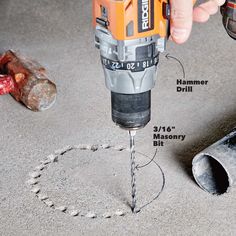 a drill is being used to make holes in the floor