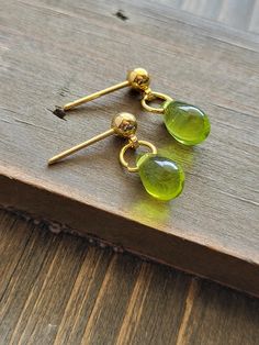 Boldly beautiful and colorful green peridot stone and gold earrings. Soft yellow stone earrings with vibrant 18k gold metal posts. One of a kind handmade jewelry piece that makes the perfect gift for a friend or loved one! Be sure to check out the BLUE EARRINGS section at EarringsbyLCreations for all beautiful blue colored earrings available! https://www.etsy.com/shop/EarringsByLCreations?section_id=28404960 Made with quality materials and always nickel and lead free metals. Naturally colorful jewelry made by hand to complement your beauty.  Perfect gift for a friend or loved one: All jewelry pieces are packaged in jewelry boxes, wrapped in burlap ribbons and gold twine thread. Rustic wrapping for gift ready giving. Personalized gift messages available. See Gift Wrapping at checkout) STAY Green Hypoallergenic Drop Earrings, Hypoallergenic Green Drop Earrings, Green Peridot Dangle Earrings, Green Peridot Drop Earrings, Gold Teardrop Peridot Earrings, Green Gemstone Drop Earrings, Handmade Green Briolette Earrings, Green Briolette Earrings For Pierced Ears, Teardrop Peridot Earrings For May Birthstone