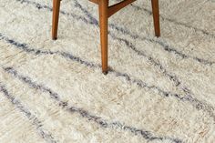 a wooden table sitting on top of a white rug