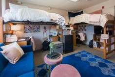 a bedroom with bunk beds and blue couches