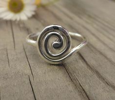 This listing is for a single sterling silver hand made spiral ring. The band of the ring is 1.5mm wide, while the spiral itself is lightly hammered flat and measures 1 cm across. Spirals are one of the oldest symbols found all over the world in ancient art and jewellery, when you see how beautifully it works as a ring, it's easy to see why. These are individually hand forged from sterling silver wire before being hammered and polished to a high shine. As they are forged rather than cast, these r Flo Outfits, Right Hand Ring, Spiral Ring, Right Hand Rings, Dope Jewelry, Hand Ring, The Spiral, Funky Jewelry, Jewelry Lookbook