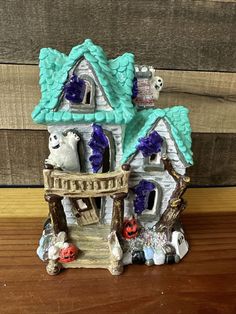 this is a figurine of a house with ghost decorations