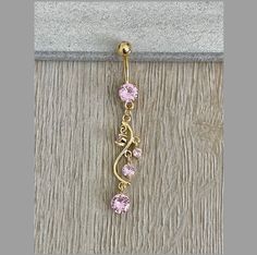 This dangly gold belly button ring features beautiful pink crystals in a long, chandelier shape. Gorgeous option for summer! Drop jaws with this body jewelry. Details & Size: ♥ Surgical Steel ♥ Cubic Zirconia ♥ Nickel Free ♥ 14G, 10mm bar ♥ Every purchase comes with an Elara gift box Please message me if you have any questions We hope you love our jewelry as much as we do! Elegant Gold Belly Rings, Elegant Gold Belly Rings Gift, Elegant 14k Gold Belly Rings For Gift, Dainty Gold Belly Rings For Wedding, Elegant 14k Yellow Gold Belly Rings, Adjustable Gold Belly Rings For Wedding, Cute Septum Rings, Unique Belly Rings, Gold Belly Button Ring