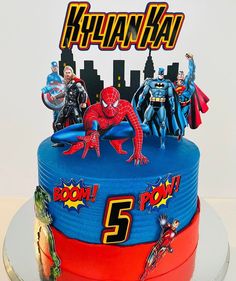 the birthday cake is decorated with superhero characters